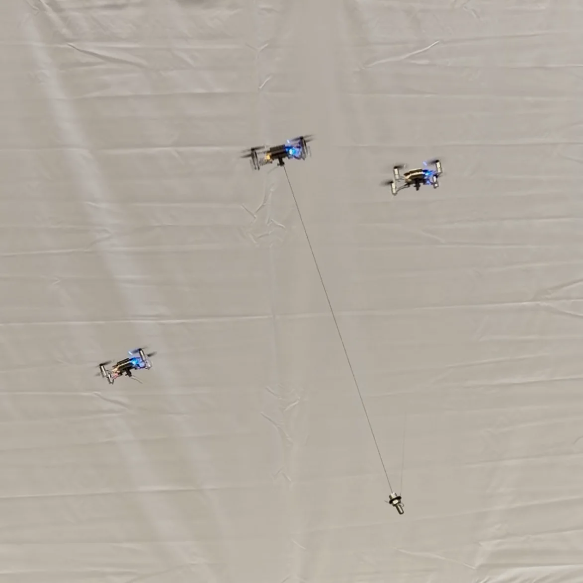 Crazyflie drones carrying a payload