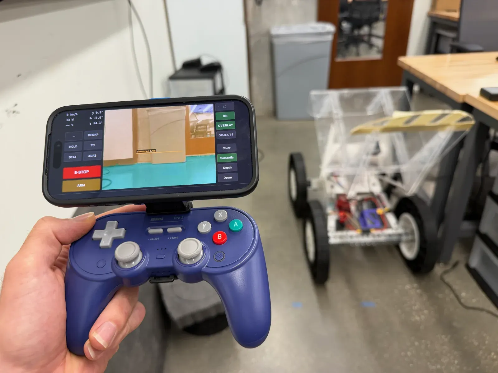 Gamepad with phone-mounted driver interface, platform in the background
